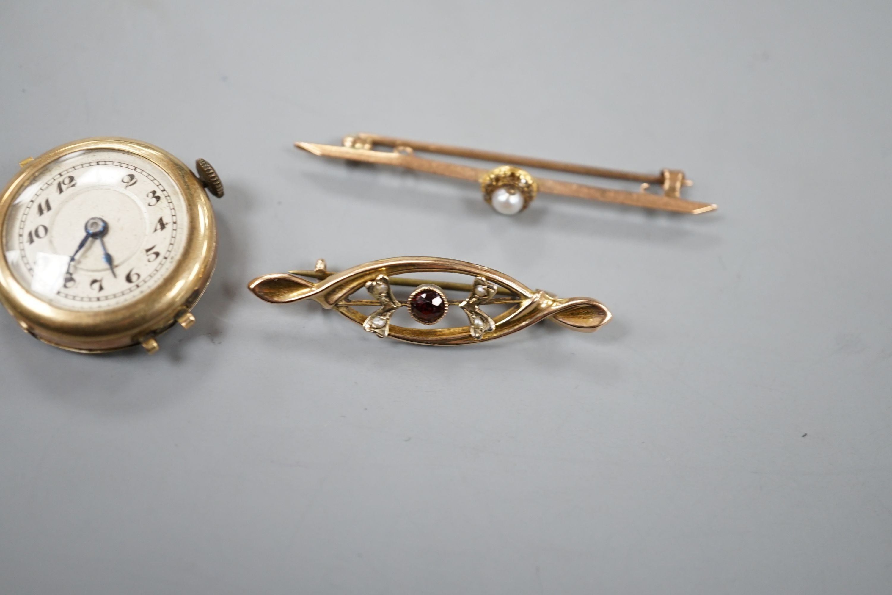 Two early 20th century 9ct and gem set bar brooches and a lady's 9ct manual wind wrist watch, no strap